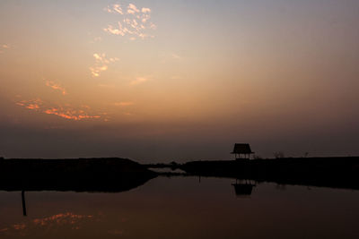 Scenic view of lake against romantic sky at sunset