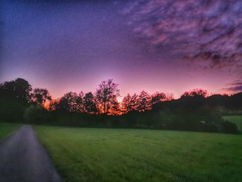 Scenic view of field against sky during sunset