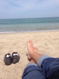 Low section of woman relaxing on beach