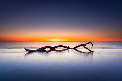 Scenic view of sea against clear sky during sunset