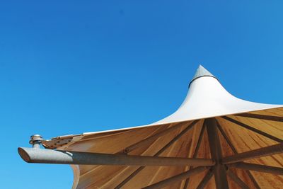 Low angle view of roof against clear blue sky