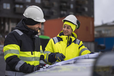 Construction engineers discussing project at construction site