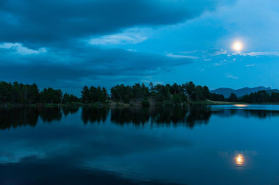 Scenic view of lake against sky at night