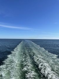 Scenic view of sea against blue sky