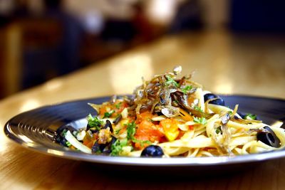 Close-up of meal served in plate on wooden table