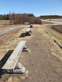 Empty road on field against clear sky