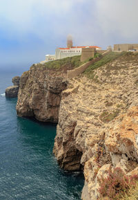 Rock formations in sea against sky