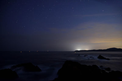 Scenic view of sea against sky at night