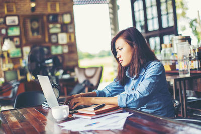 Woman sitting on table at cafe