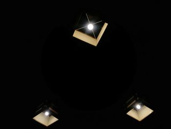 Low angle view of illuminated light bulb in the dark