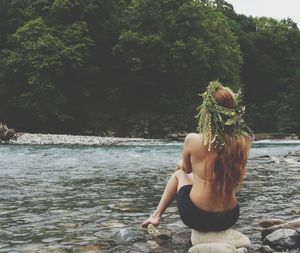 Rear view of woman sitting in park