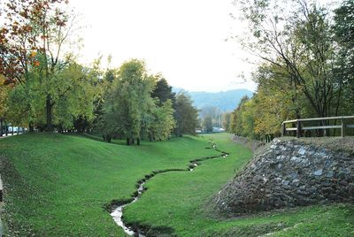 Scenic view of golf course against sky