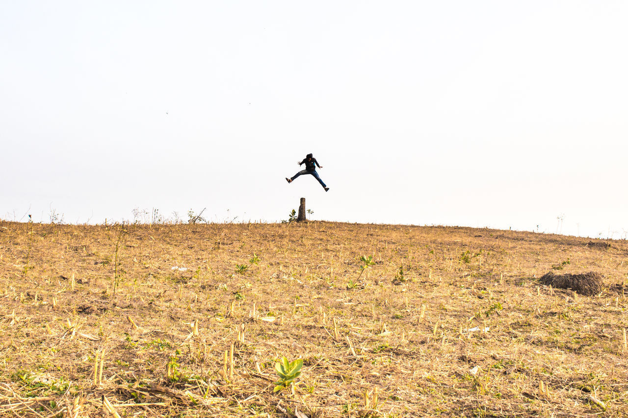 MAN JUMPING ON FIELD