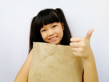 Portrait of a smiling young woman over white background