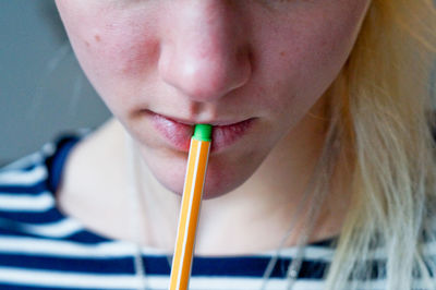 Midsection of young woman holding pen