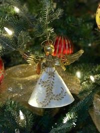Close-up of christmas decoration hanging on tree at night