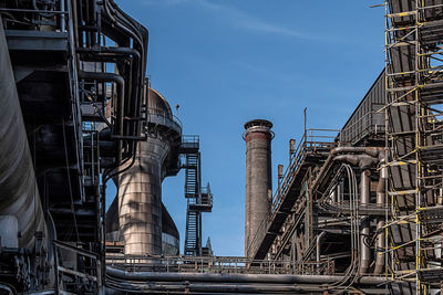 Low angle view of factory against sky