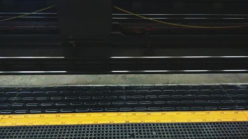 Close-up of yellow railroad station platform