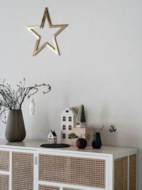 White flowers on table against wall at home