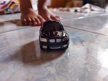 Low section of woman wearing shoes on table