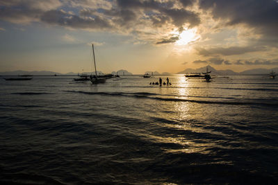 View of boats in calm sea against sky