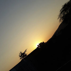 Low angle view of silhouette tree against sky during sunset