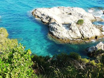 High angle view of rocks in sea