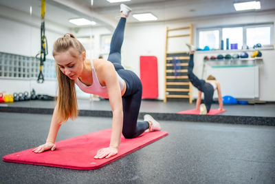 Young woman exercising in gym