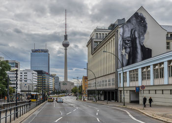 View of city buildings against cloudy sky