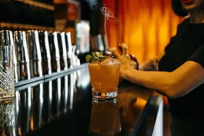 Midsection of man holding beer glass