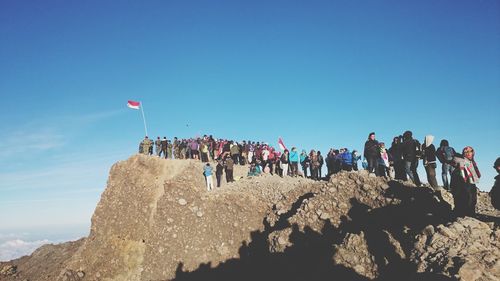 Silhouette of people against blue sky