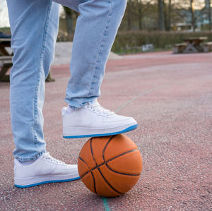 Low section of man playing basketball