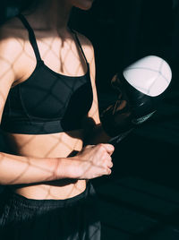 Midsection of boxer wearing glove