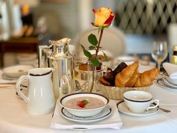 Close-up of coffee and cups on breakfast table