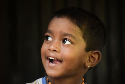 Portrait of happy boy looking away