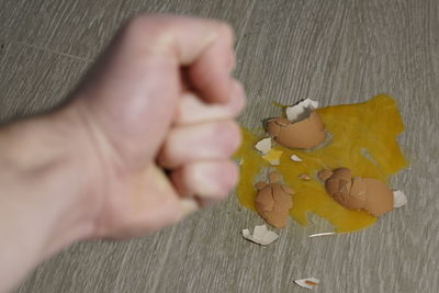 Close-up of hand holding yellow leaf