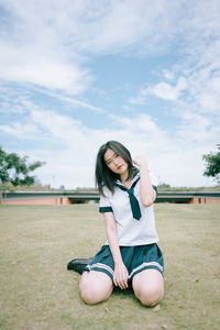 Portrait of woman sitting on field