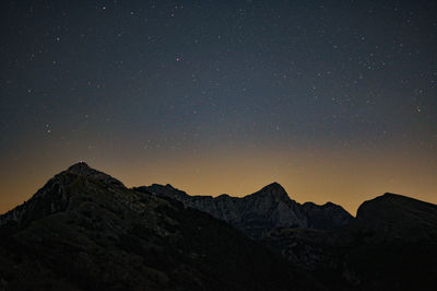 Scenic view of mountains against sky at night