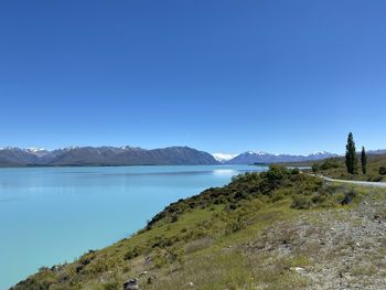 Scenic view of lake against clear blue sky