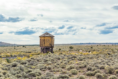 Built structure on field against sky
