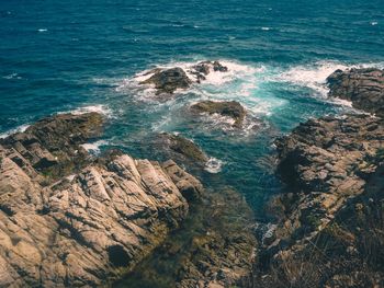 High angle view of rocks in sea