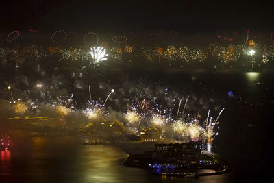 Firework display in city at night