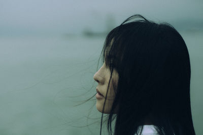 Side view of young woman in water