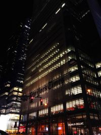 Low angle view of illuminated skyscraper at night