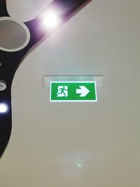 Low angle view of illuminated sign on ceiling