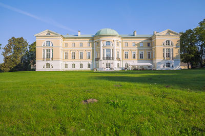 Lawn by building against sky