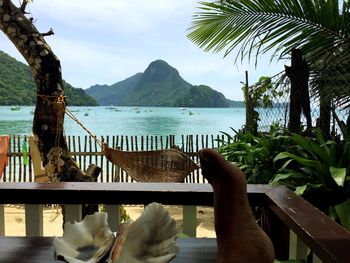 Scenic view of sea and mountains against sky