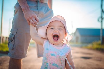 Midsection of mother and daughter outdoors