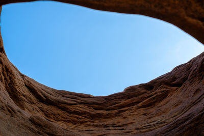 Low angle view of mountain against clear blue sky