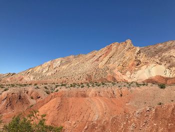 Scenic view of mountain against blue sky